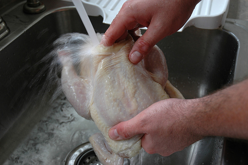 Clean chicken under water. Clean chicken